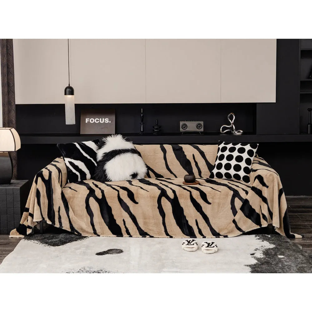 Zebra pattern flannel sofa cover in a caramel colour, shown draped over a sofa.