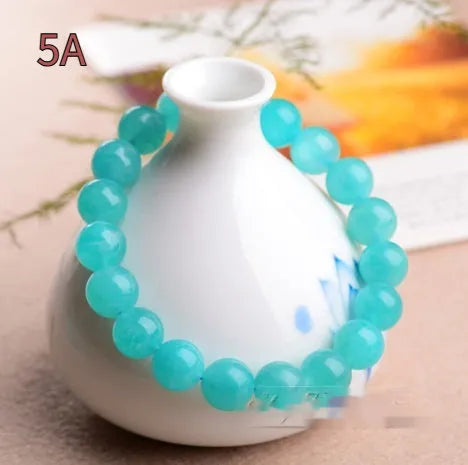 Grade 7A Amazonite natural stone scattered beads arranged on a bracelet, showing blue-green colour and polished finish.