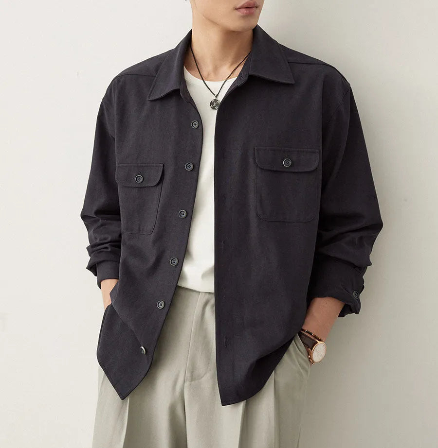 Men's light sand rice coloured long sleeve shirt with a simple lapel, laid flat.