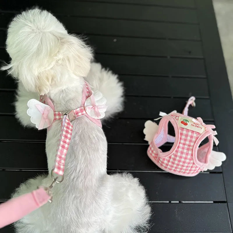 Small dog wearing pink cotton chest and back harness with leash attachment points