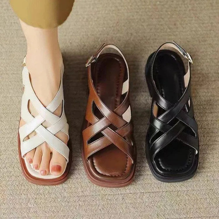 Women's glossy black patent leather sandals with square toe and cross-belt fastening
