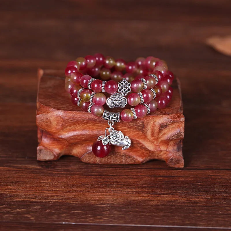 Natural watermelon crystal bracelet with Chinese knot fastening showing bi-colour gemstone beads
