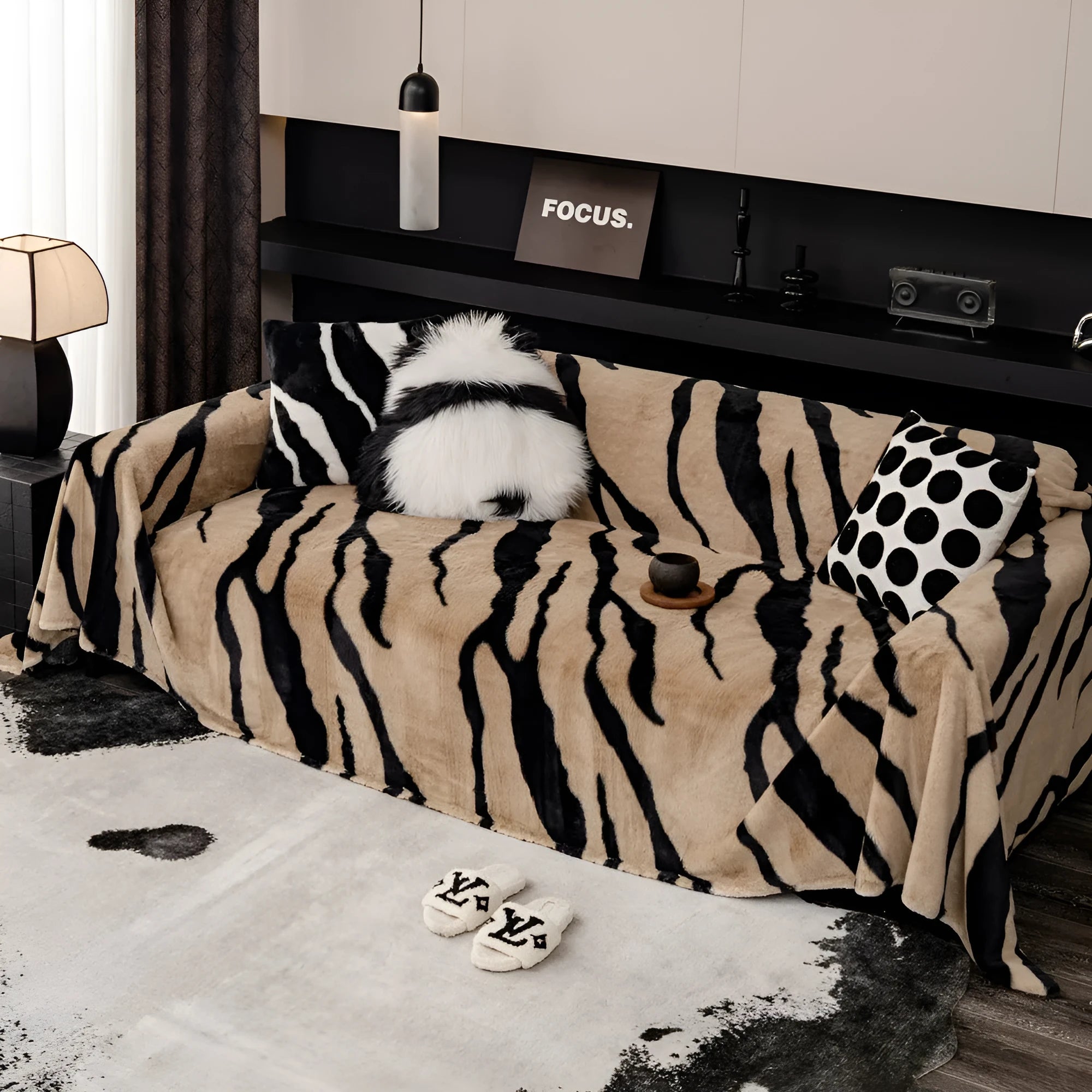 Zebra pattern flannel sofa cover in a caramel colour, shown draped over a sofa.