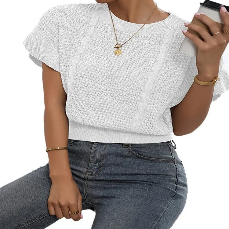 Loose fit knitted pullover sweater with twisted string pattern and ruffled short sleeves on a hanger.