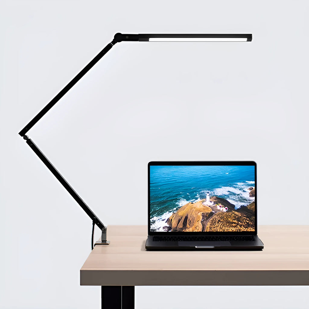 Black clip mount LED desk lamp with dimmer switch attached to study desk edge