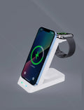 Black and white 3-in-1 wireless charging dock standing upright with phone on stand