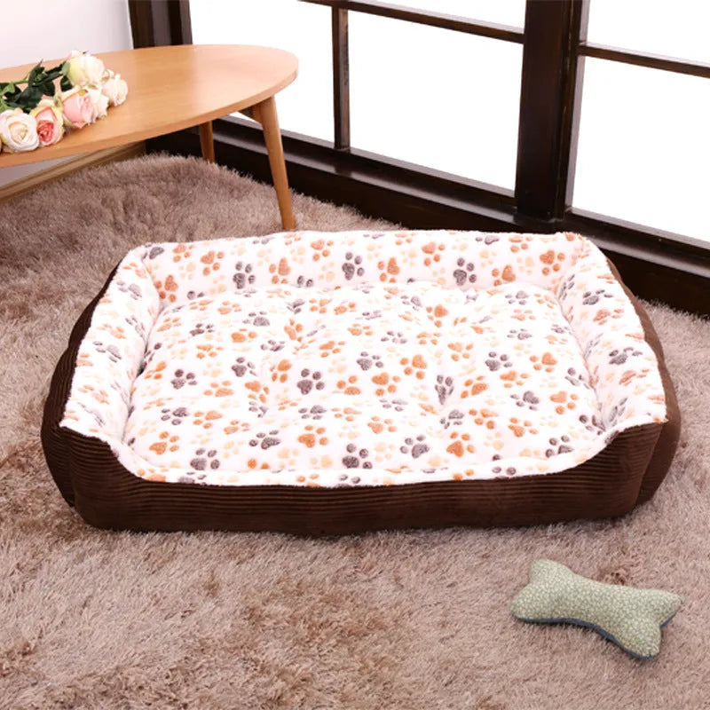 Beige plush dog bed with removable cover on a wooden floor, shown next to a small dog.