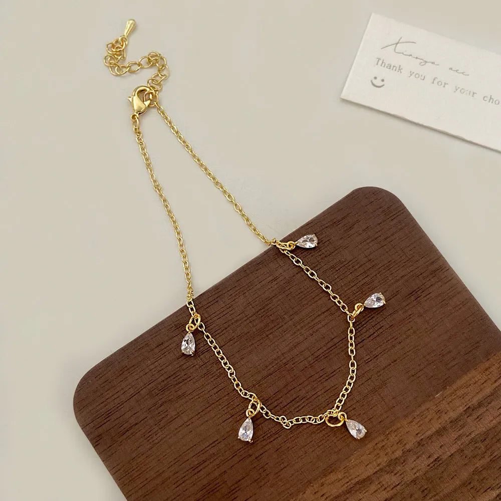 Zircon jewellery set with meteor shower geometric pendant necklace, matching earrings, and anklet