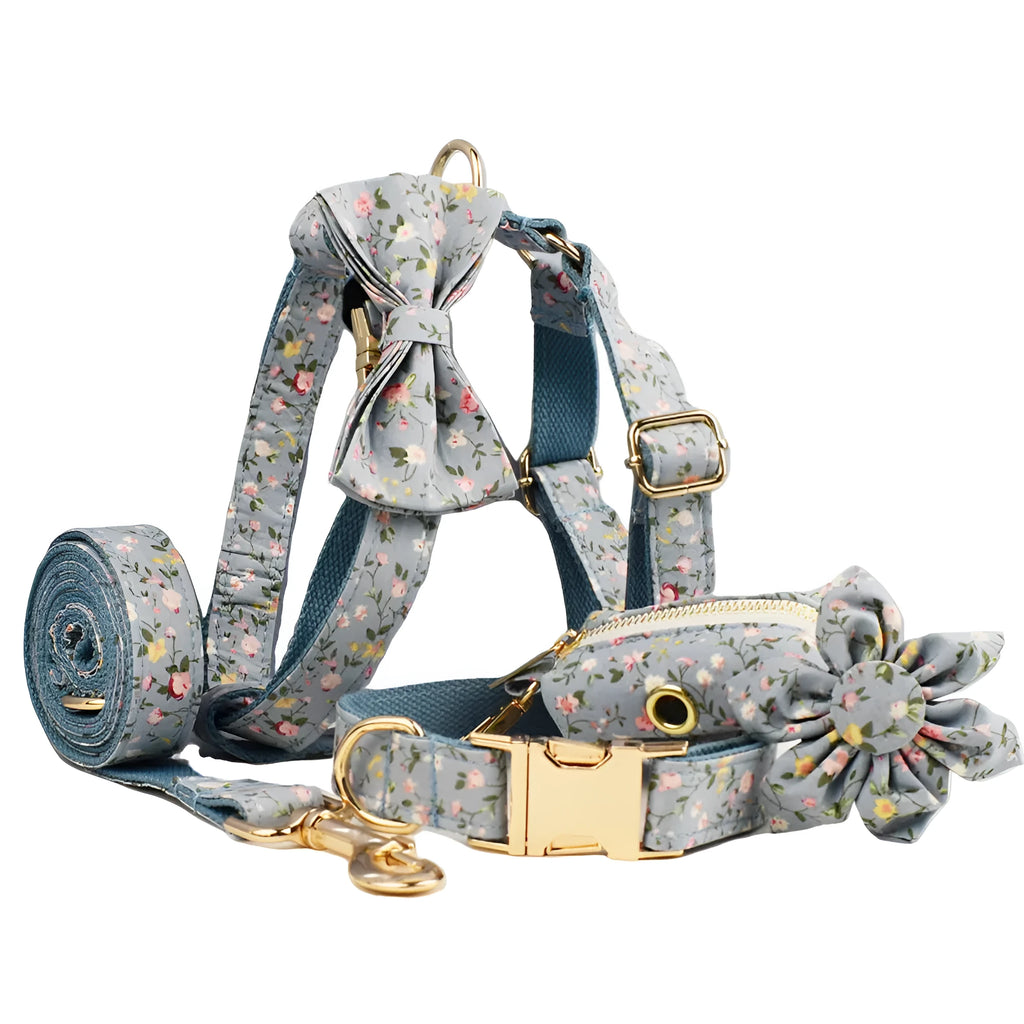 Blue floral pattern dog collar with matching leash, bow tie, vest and waste bag accessories on white background