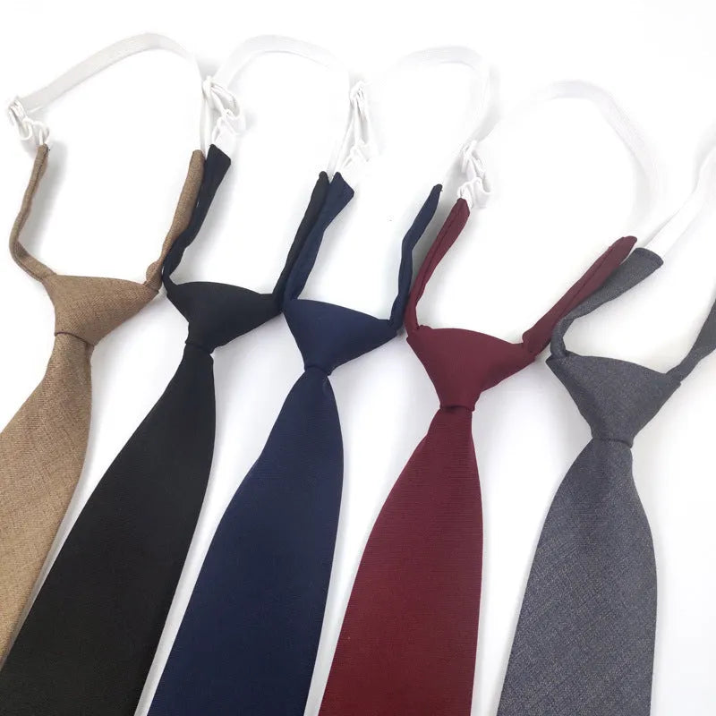 Men's solid navy blue cotton tie on a white background, showing its arrow shape and dimensions.