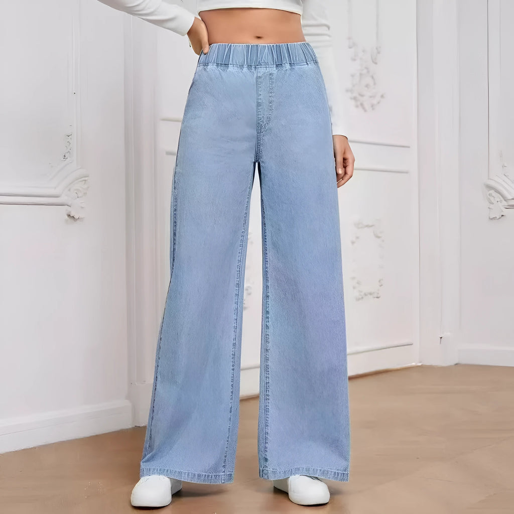 Light blue washed wide-leg straight jeans on a hanger, showing zip fly and mid-waist design.