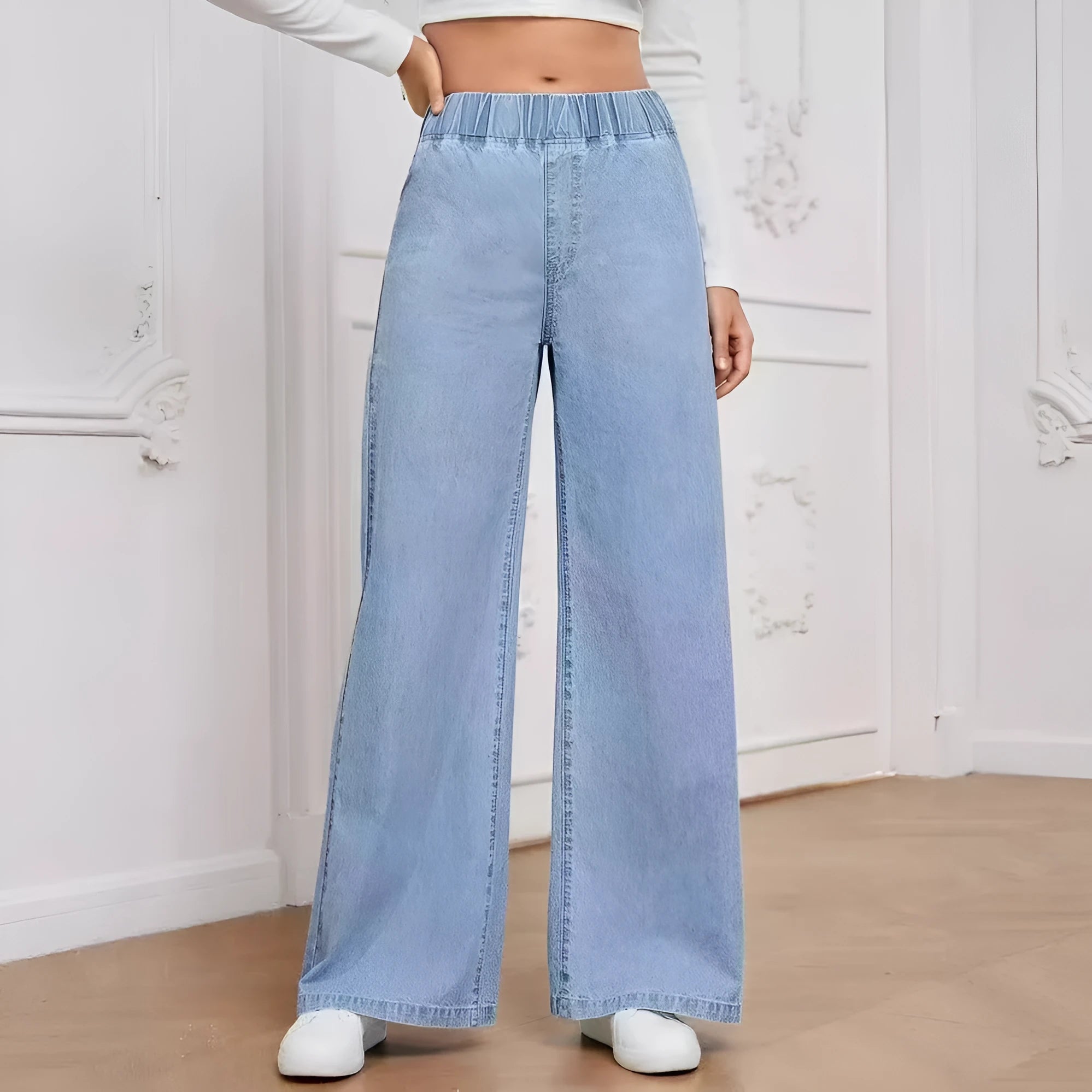 Light blue washed wide-leg straight jeans on a hanger, showing zip fly and mid-waist design.