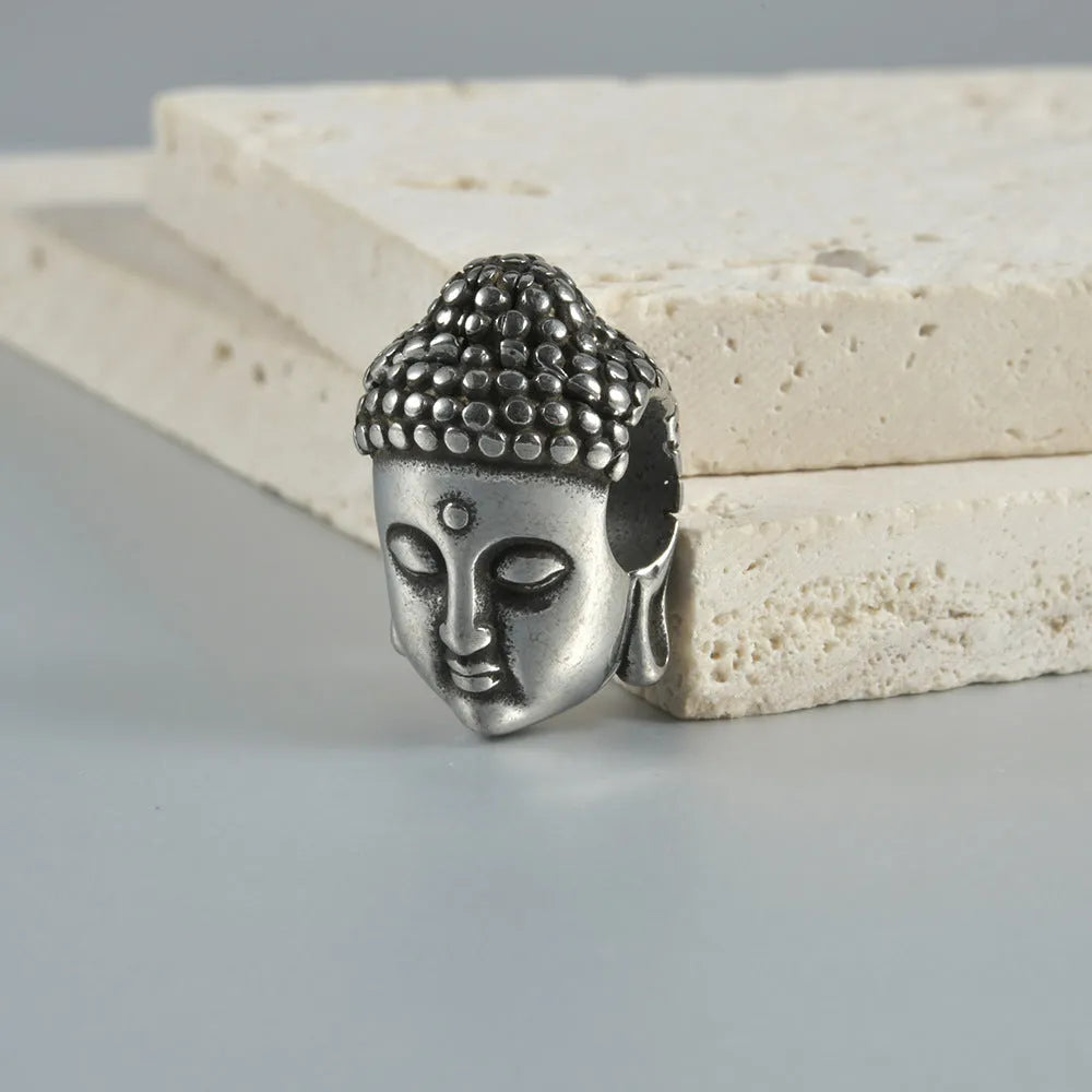 Stainless steel hollow skull Buddha earring for auricle piercing in hip hop style.