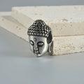 Stainless steel hollow skull Buddha earring for auricle piercing in hip hop style.