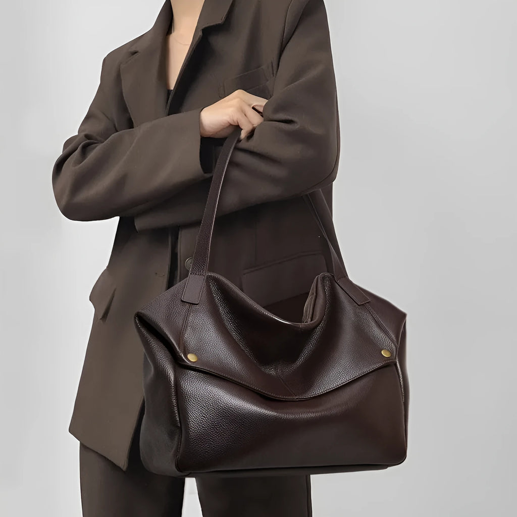 Brown genuine leather women's shoulder bag with horizontal square shape showing interior zipper compartment
