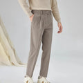 Men's straight-leg corduroy trousers in beige on a hanger, showing the textured fabric and mid-waist design.