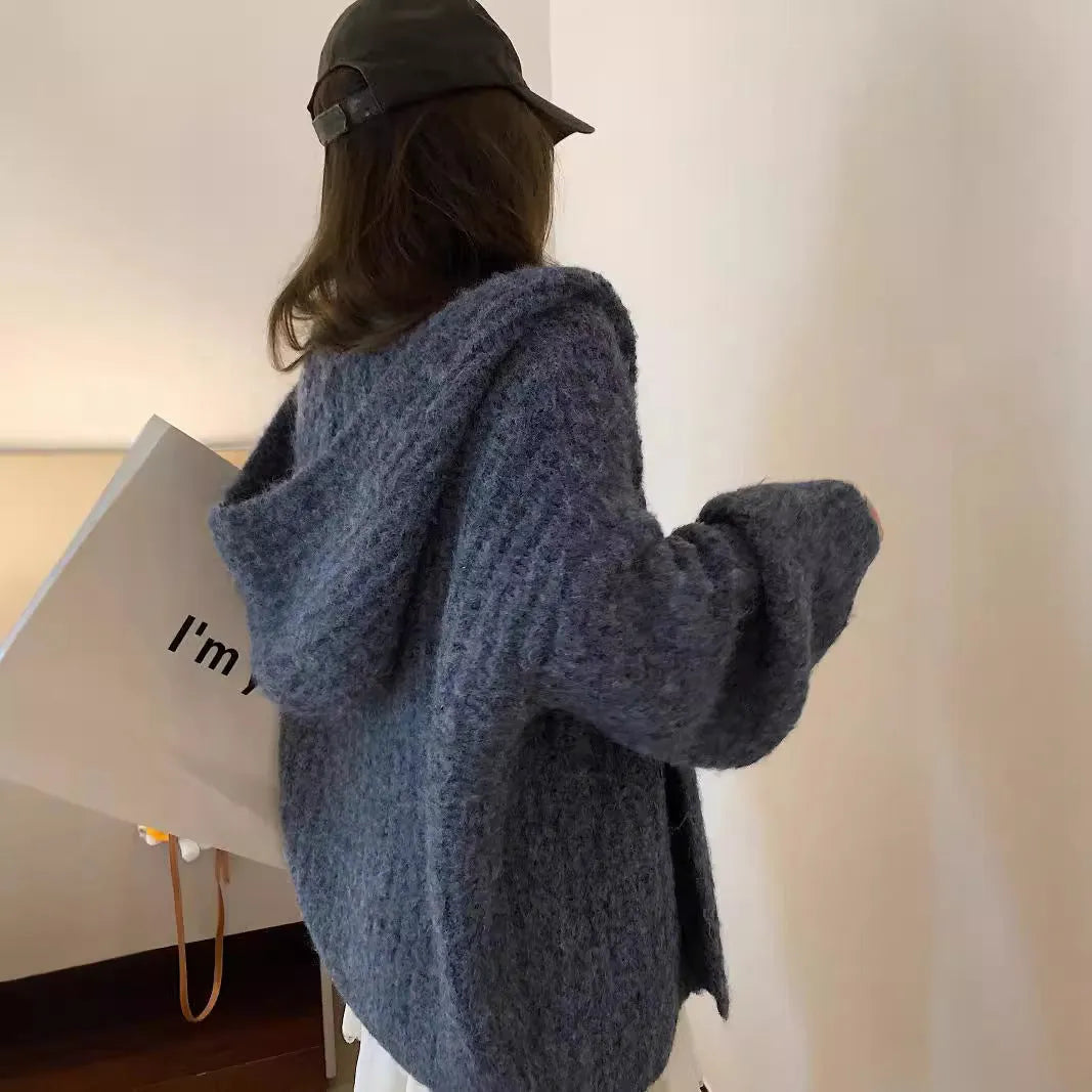 Woman wearing a brown retro-style Maillard hooded cardigan with a thick knit and loose fit.