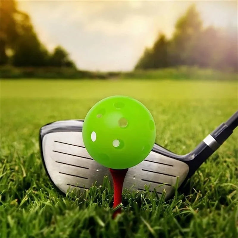 Multi-coloured golf practice balls in net storage pocket for putting training