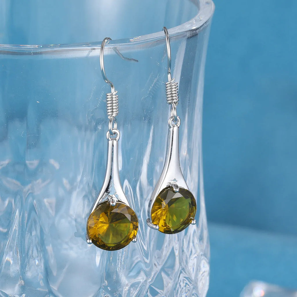A pair of olive green retro-style drop earrings made from alloy on a white background.