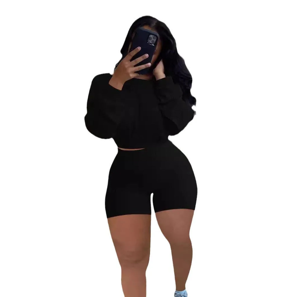 Women's off-the-shoulder long sleeve top and shorts two-piece set in a solid colour.