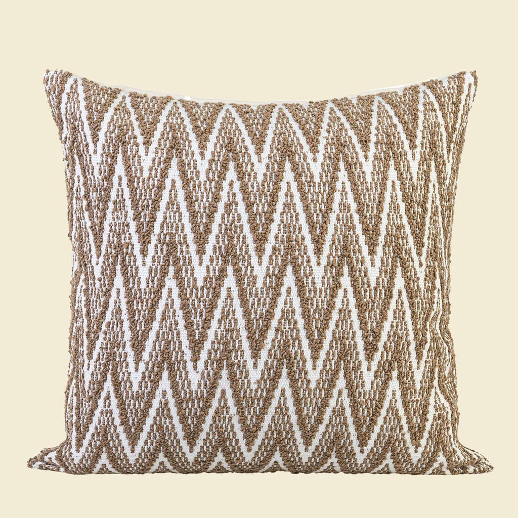 Chinese style square cushion with geometric pattern in Maillard brown colour on a sofa.