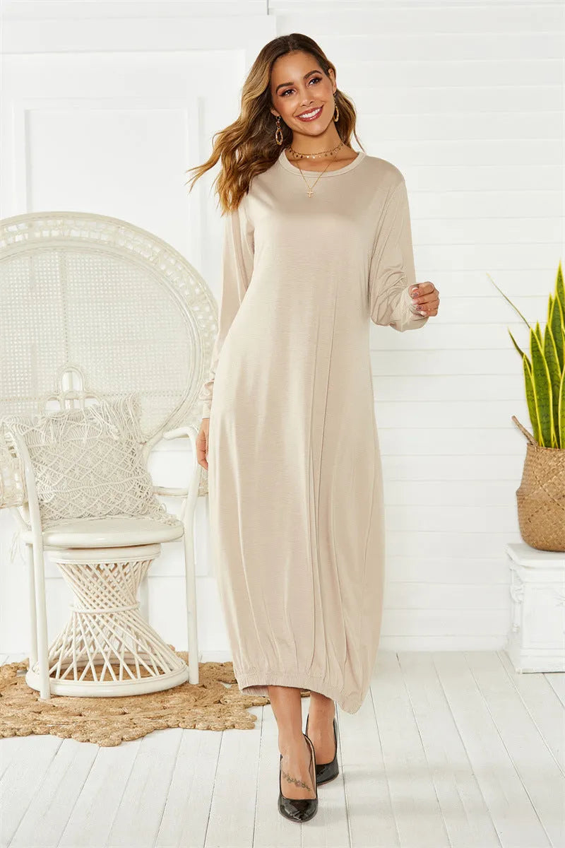 A loose black lantern dress with a lace-up crew neck, shown on a model.