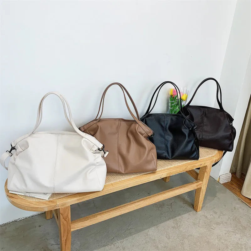 Large soft surface PU messenger bag in a horizontal square tote style with a shoulder strap.