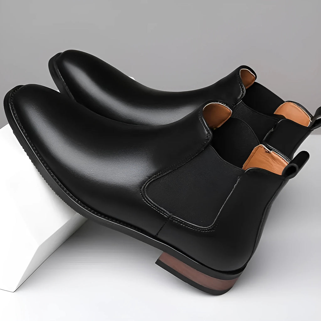 Men's black Chelsea boots with pointed toe design and artificial PU leather construction