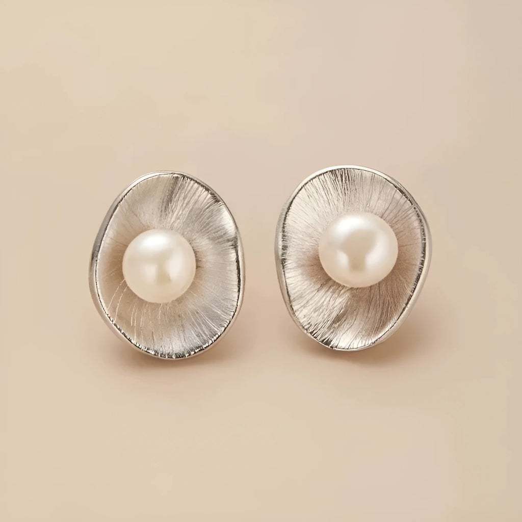 Gold electroplated sterling silver pearl ear studs with geometric design and surgical steel posts
