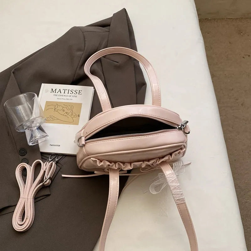 PU leather ladies shoulder handbag with phone compartment in milky white colour showing decorative stitching