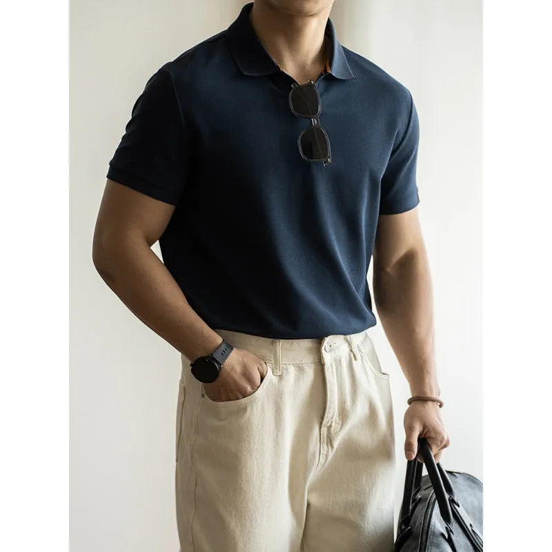 Men's blue short-sleeved cotton blend polo shirt on a hanger, showing regular fit and casual style.
