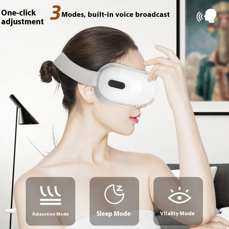 White rechargeable eye massager with airbag massage and hot compress function on a table.