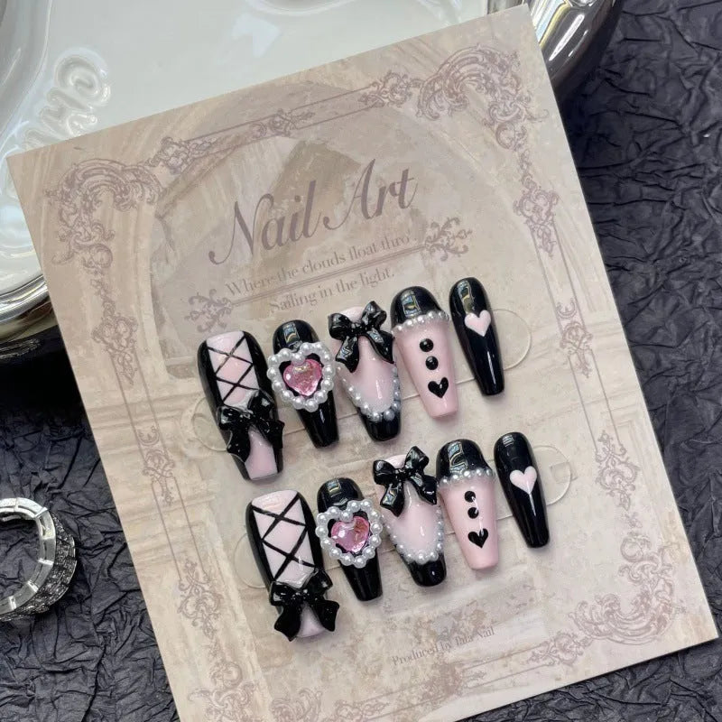 Black and pink heart design hand-painted manicure nails with cat's eye styling