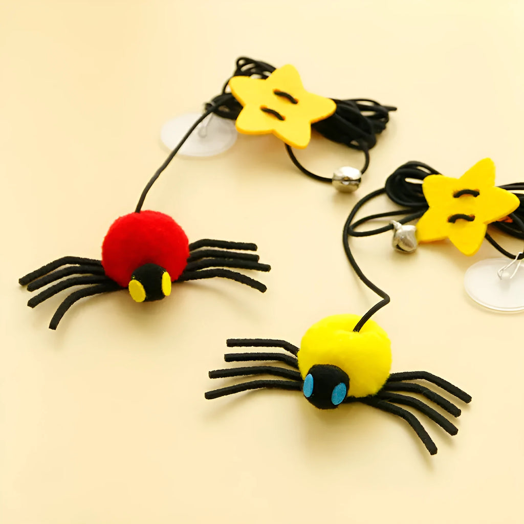Red and yellow hanging door cat toy with feather, bell, spider, and elastic rope for interactive pet play